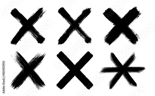 Set of hand-drawn X marks in black brush stroke style