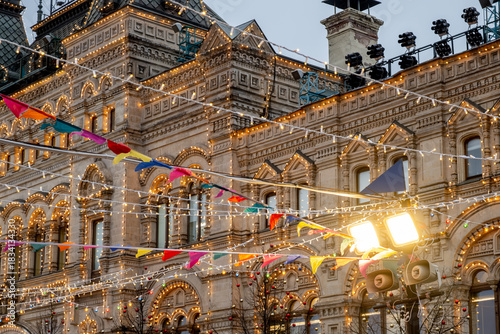 Photography Illuminated facade of GUM and festive flags on the Red Square, decorated for the