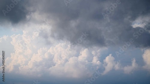 Time lapse of dynamic clouds moving over the mountains of Ruifang New Taipei City Taiwan in the winter afternoon. Combination of bright blue sky white clouds and dark gray clouds.