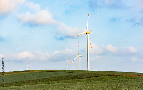 Aerial view of the sunset and windmills over the pineapple sea in Xuwen County, Zhanjiang.