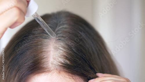 Nourishing vitamin serum applied along the parting to fight gray hair and support healthy follicle function. Vitamin serum massaged into scalp to reduce early gray hair and nourish weak follicles