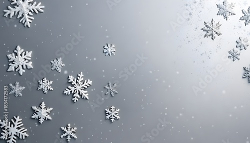 A beautiful close-up of delicate white snowflakes falling against a soft grey background, creating a serene winter wonderland ambiance