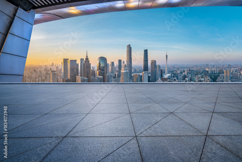Empty square floor and city skyline with modern commercial buildings at sunrise in Guangzhou