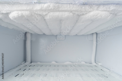 Fotografia Interior of freezer compartment covered with uniform frost on evaporator ribs, c