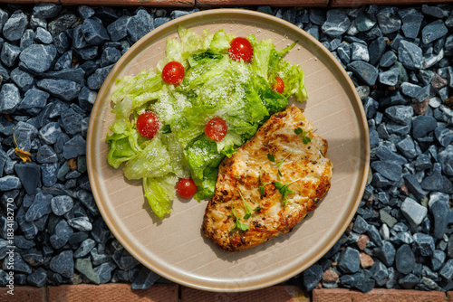 Grilled Chicken Breast With Fresh Green Salad On Plate Outdoors