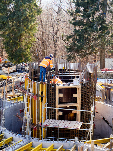 Construction Site of a Round Concrete Structure in a Forest Setting
