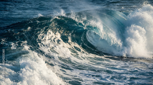 Fototapeta Naklejka Na Ścianę i Meble -  A dramatic and powerful ocean wave crashing with force, revealing detailed textures of water, foam, and motion. The deep blue tones and dynamic energy capture the beauty and strength of the sea in a b