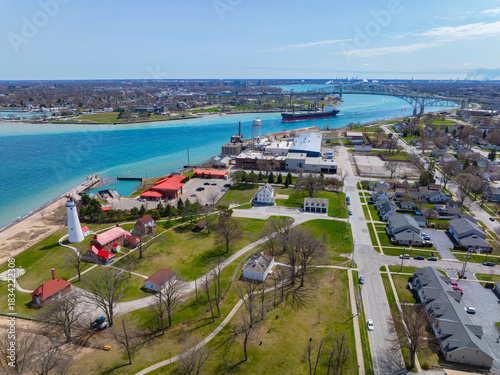 Fort Gratiot Lighthouse aerial view at the entrance to the St. Clair River from Lake Huron, with Blue Water Bridge at the distance, in city of Port Huron, Michigan MI, USA. 