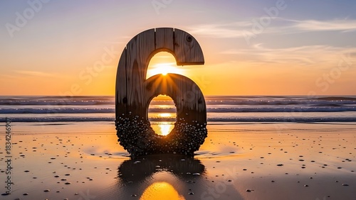 Stock photo of number six on beach at sunset, wooden number six on sand, beach photography