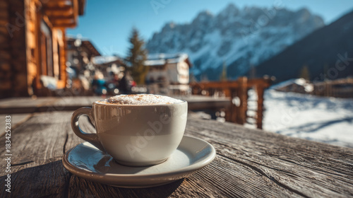 A cup of cappuccino coffee on a table in a cafe at a ski resort