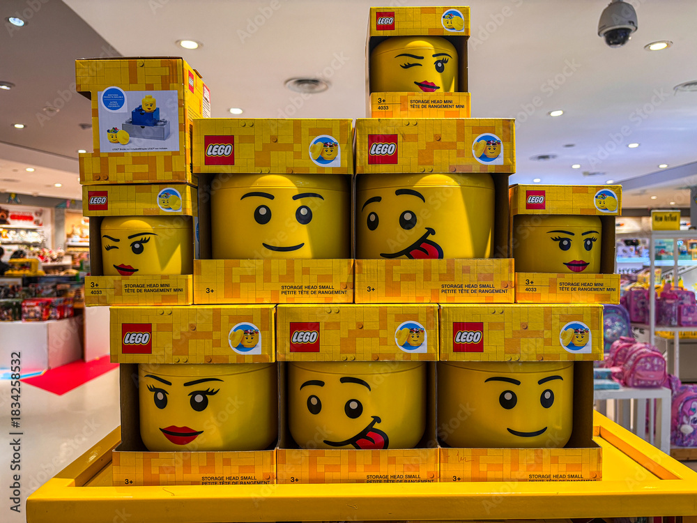 Obraz premium Lego Character Head Containers on Display in a Bright Retail Store
