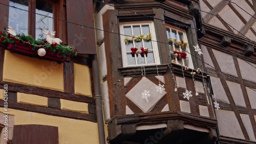 Eguisheim, France - 3.12.2025: A small, beautiful village decorated for Christmas. People stroll through the beautifully decorated streets of the French village of Eguisheim