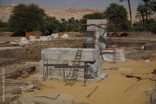Construction of new concrete bases on which, once completed, further monumental stone statues from the 18th Dynasty of Ancient Egypt will stand.  Temple in Thebes near Luxor, Egypt.