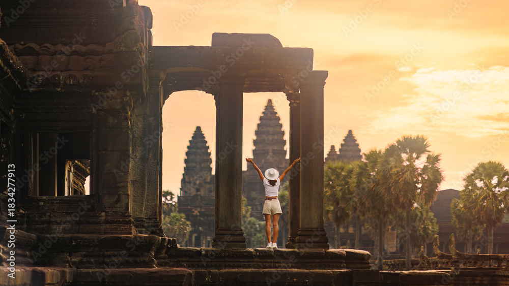 Naklejka premium Celebrating Sunrise At Angkor Wat Columns, Female Backpacker, Cambodia