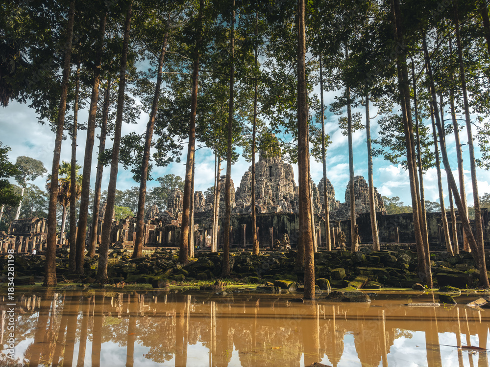 Naklejka premium Bayon Temple Framed By Jungle Trees And Reflection Pool, Cambodia