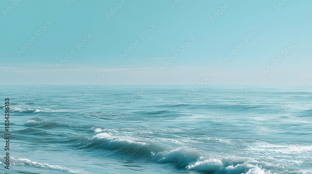 Fototapeta premium Serene ocean waves gently rolling under clear blue sky with calm water and distant horizon in a peaceful seascape scene