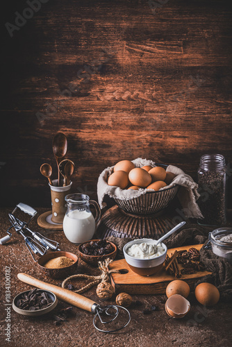 Assorted baking ingredients on rustic bronw table