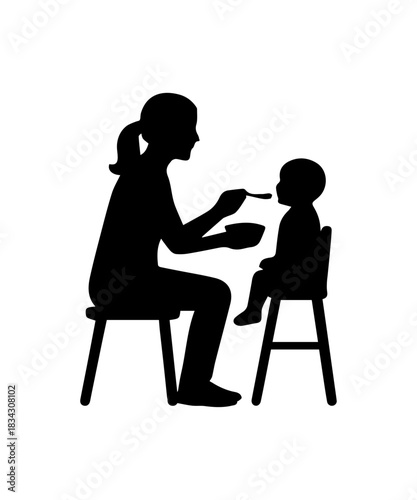 Mother feeding baby in high chair silhouette