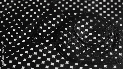 Hand Wipes Polka Dot Surface Revealing Black Glossy Texture