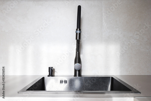 kitchen faucet on a stylish metal sink