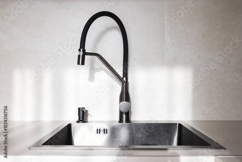 kitchen faucet on a stylish metal sink