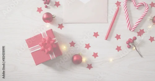 Fototapeta samoprzylepna Displaying red box with white ribbon and bow on pale wood tabletop, featuring candy cane heart