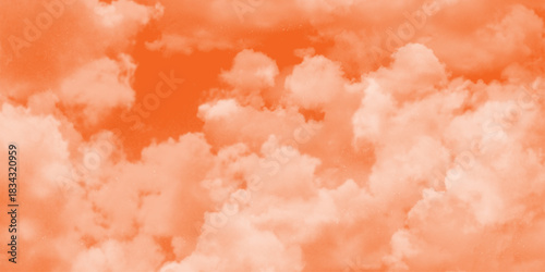 Pink Clouds Against a Warm Orange Sky at Sunrise. fantasy blurred cloudy sky with gradient color and grunge paper texture . White clouds in a sky. Light brown aesthetic. Monochrome cloudscape concept 