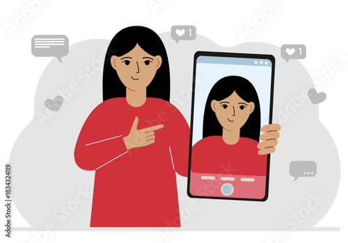 A female video blogger records or watches a video or photo on a smartphone. Various social media icons.
