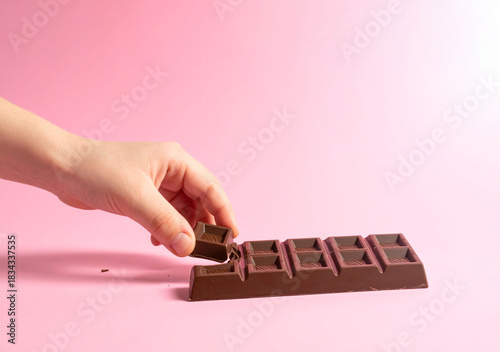 main qui prend du chocolat en tablette