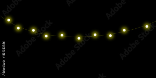 A string of glowing yellow fairy lights hanging in a gentle curve against a solid black background.