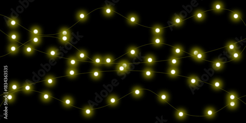 Strings of warm yellow glowing fairy lights arranged against a solid black background, creating a festive and magical atmosphere.