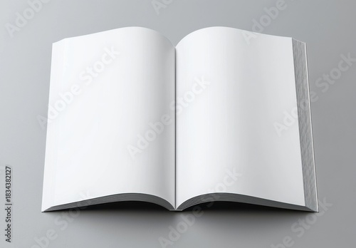 Book mockup lying on gray surface, dark cover splayed open, revealing pristine white pages, minimalist design ideal for graphic presentations