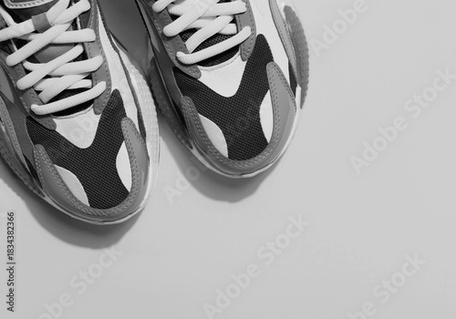 Multicolor sport shoes on yellow background with shadows