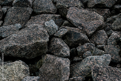 Coarse stones displaying weathered edges and diverse mineral colors