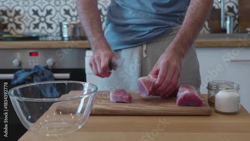 Preparing Meat. Male Hands Cutting Raw Pork or Beef on a Kitchen Counter.