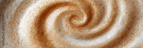 Close up abstract texture of a creamy coffee latte foam with a perfect spiral pattern, ideal for cafe menus or beverage backgrounds.