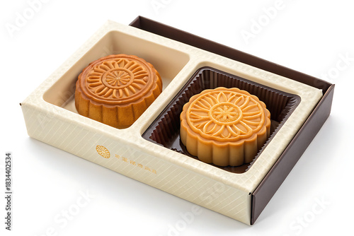 Two traditional mooncakes in a decorative gift box