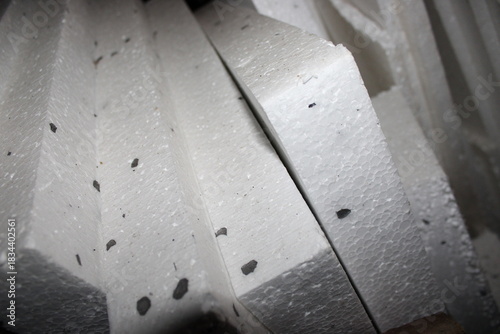 Pieces of white foam stacked in a workspace for future use in construction or insulation projects