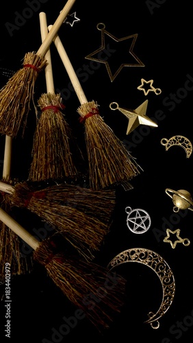 Witch brooms and magical symbols on black background occult charms, moon, stars and pentagram for mystical rituals and witchcraft