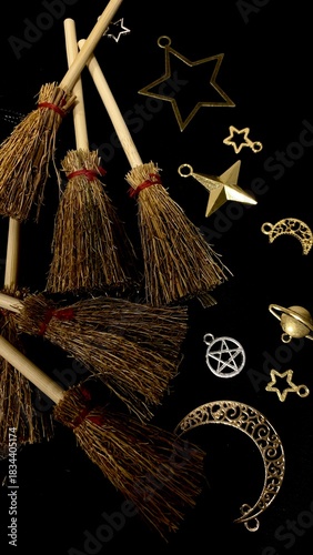 Witch brooms and magical symbols on black background occult charms, moon, stars and pentagram for mystical rituals and witchcraft