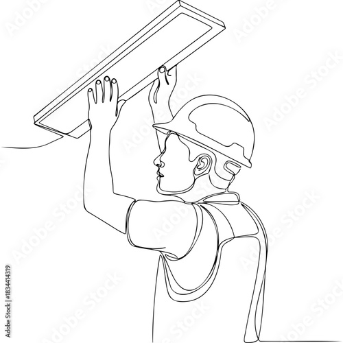 Construction worker installing laminate flooring in attic  