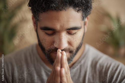 Hispanic man practicing breathwork in a calm wellness studio with warm lighting and sound-healing bowls. Peaceful, authentic holistic wellness moment. Hispanic man, in his 30s, participating in holist