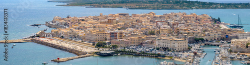 Panorama of the island of Ortigia, Sicily, Italy. View from above of the historic center of Syracuse, located along the coast of the Mediterranean. The city is a destination for many tourists.