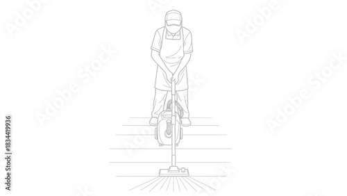 Person in apron vacuuming a floor with a push vacuum cleaner