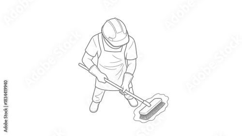 Person in hard hat and apron sweeping with a brush