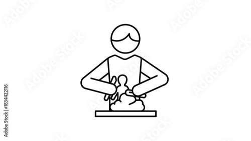 Person sculpting clay or dough from a top down view