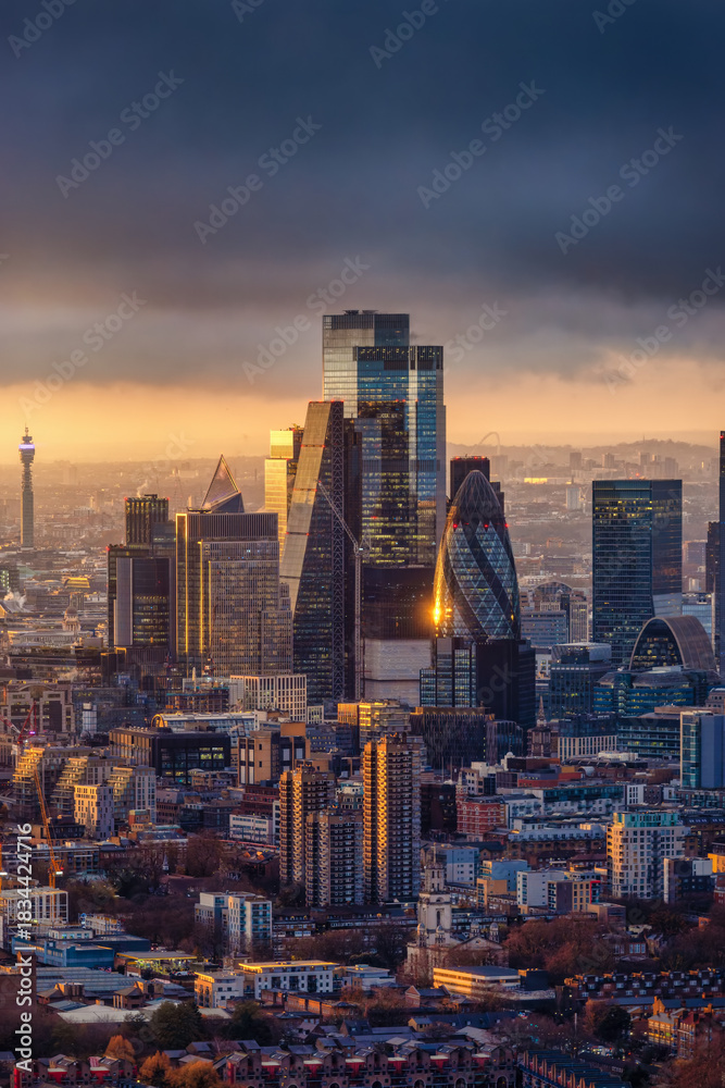 Fototapeta premium Elevated winter sunset view of the City of London skyscraper cluster, financial hub of England, with the facades reflecting the sunlight