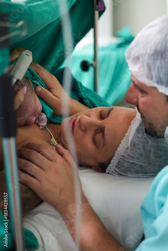Newborn baby and mother during childbirth in hospital delivery room