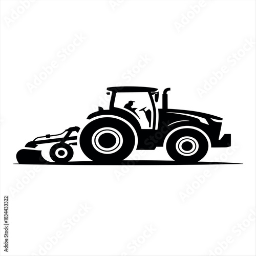 Silhouette of a tractor pulling a tilling implement