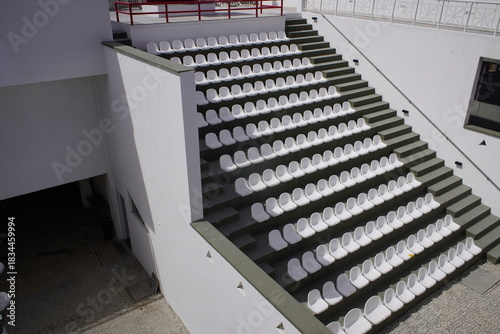 Photography Open-air grandstand with white seats integrated into a concrete structure